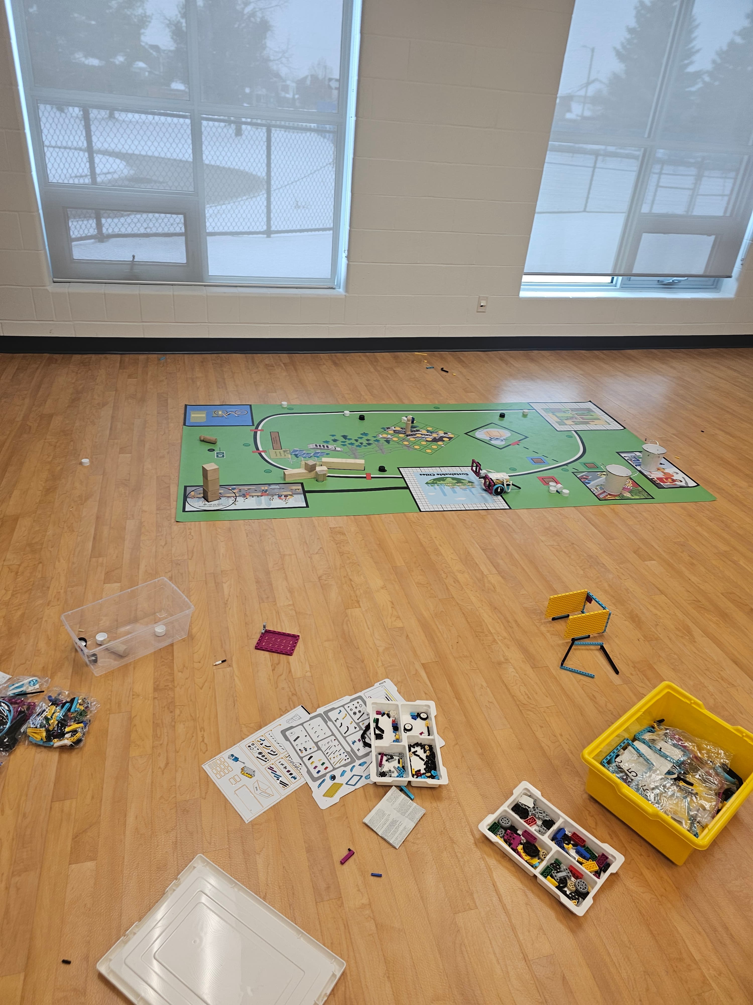 LEGO robotics activity mat with building materials laid out on a classroom floor at Blue Willow Public School