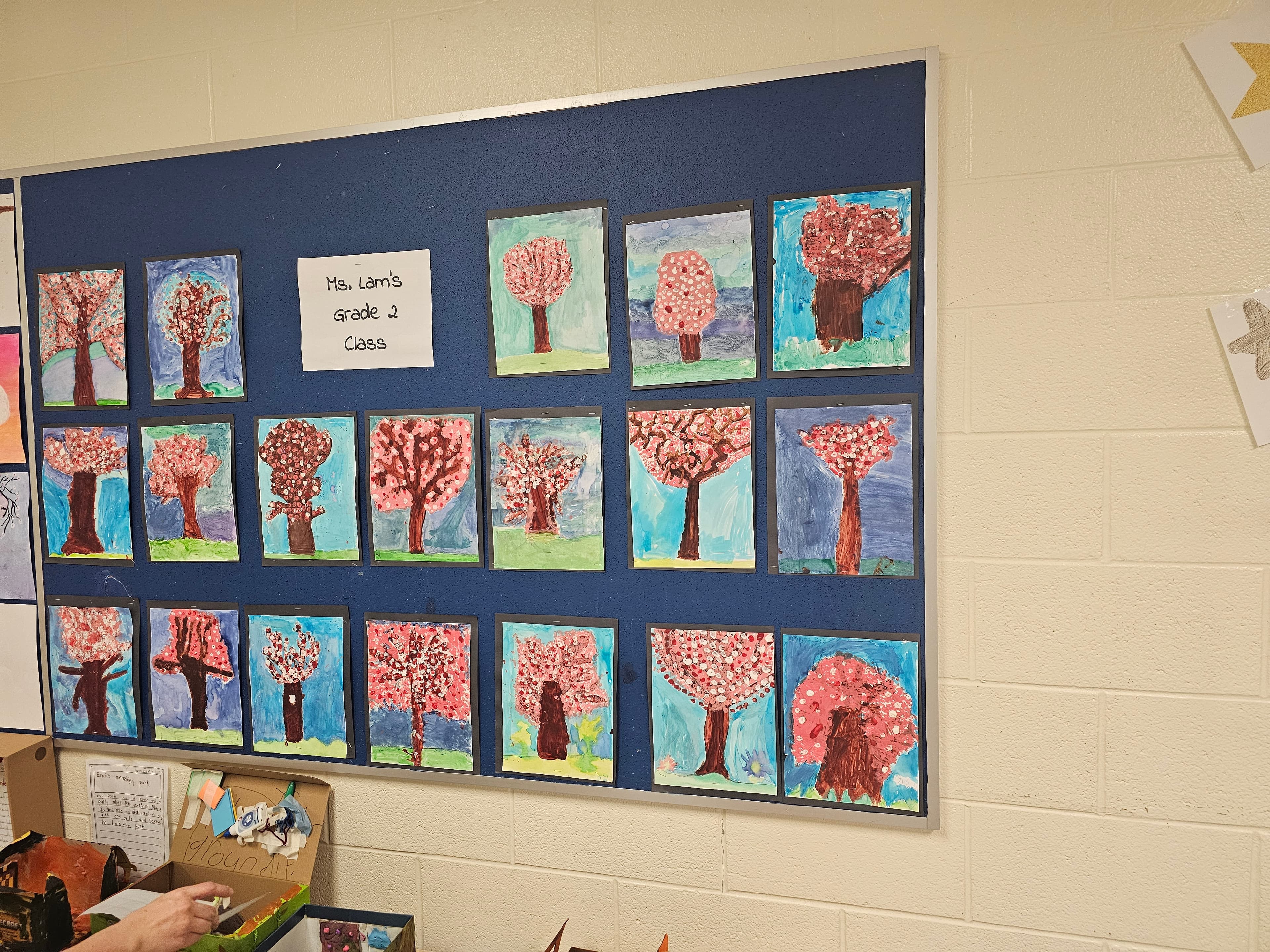 Classroom bulletin board displaying student cherry blossom paintings at Blue Willow Public School