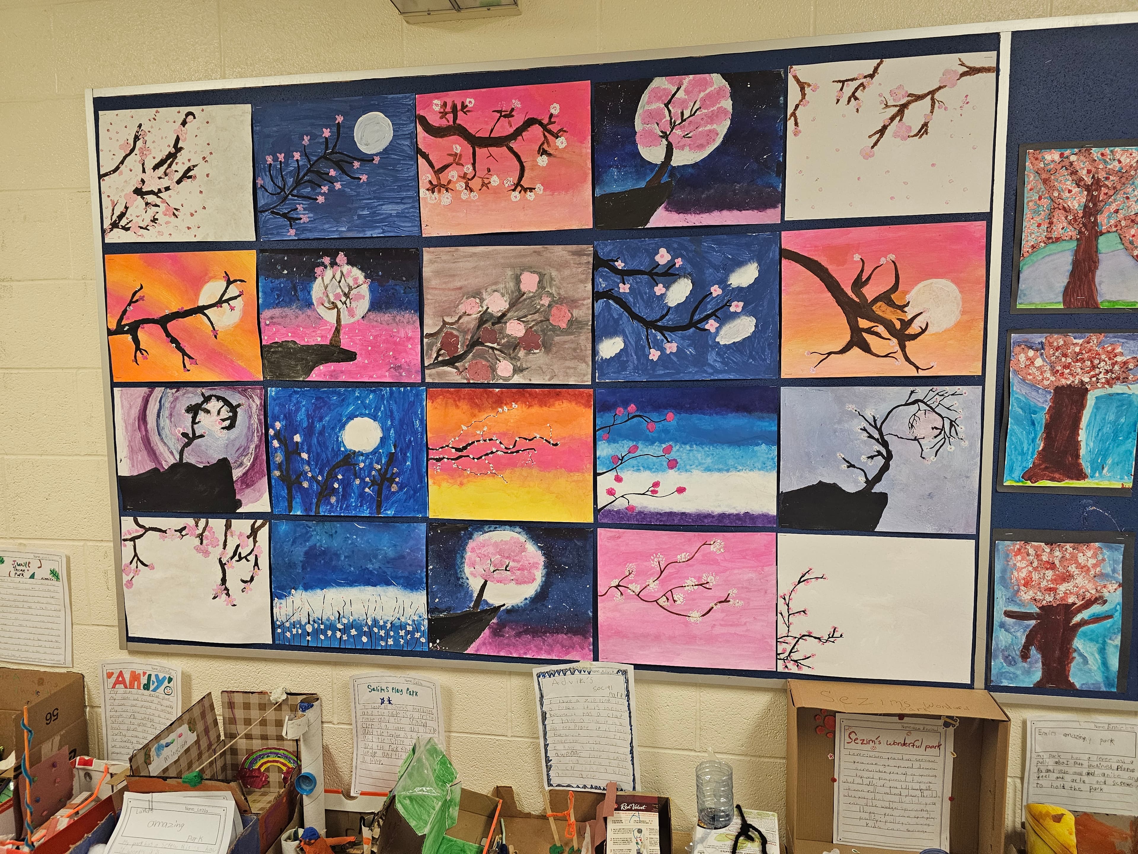 Student paintings and three-dimensional park models displayed together in a classroom at Blue Willow Public School