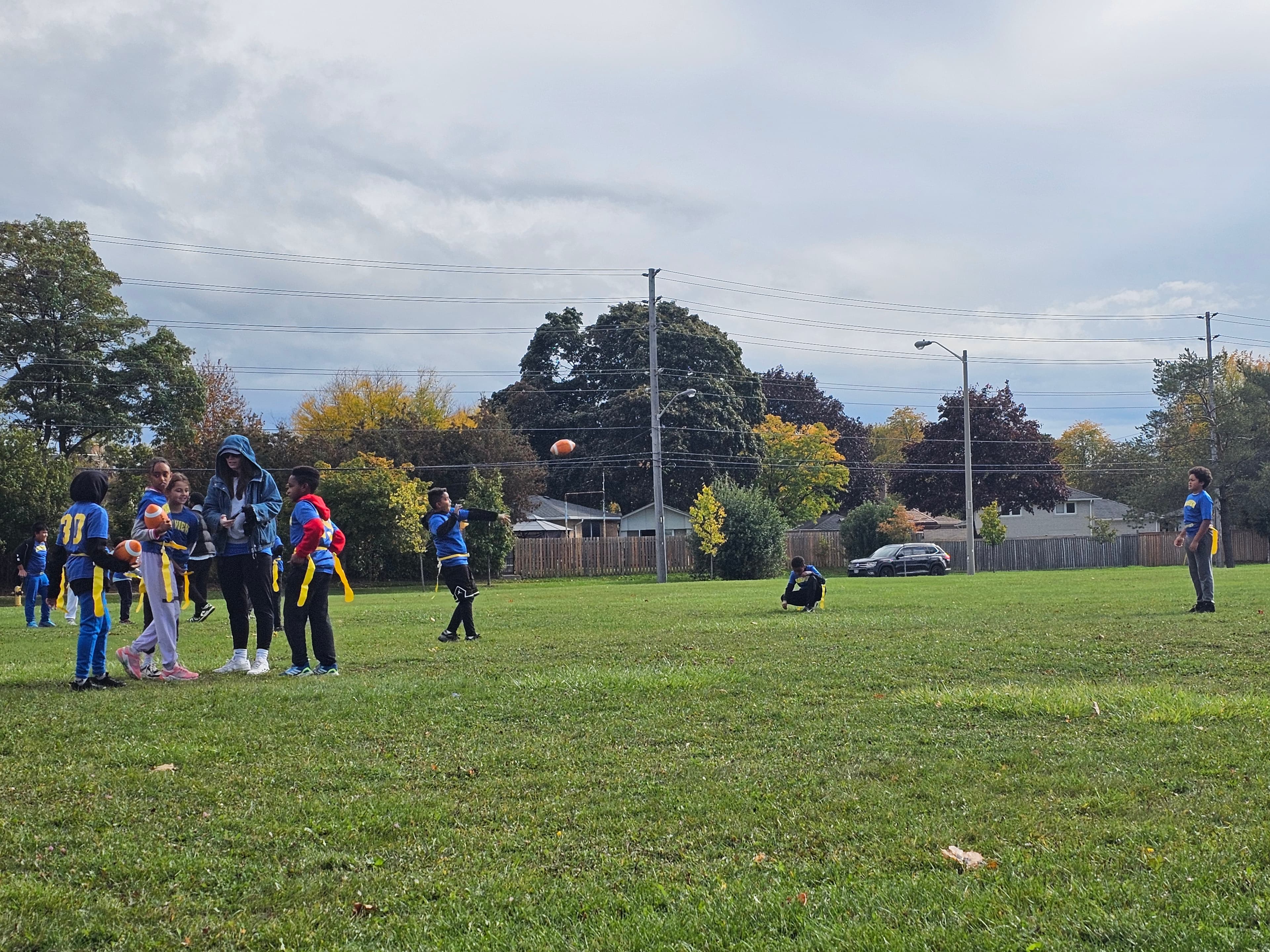 Wide view of a school field during an outdoor physical education game at Highview Public School