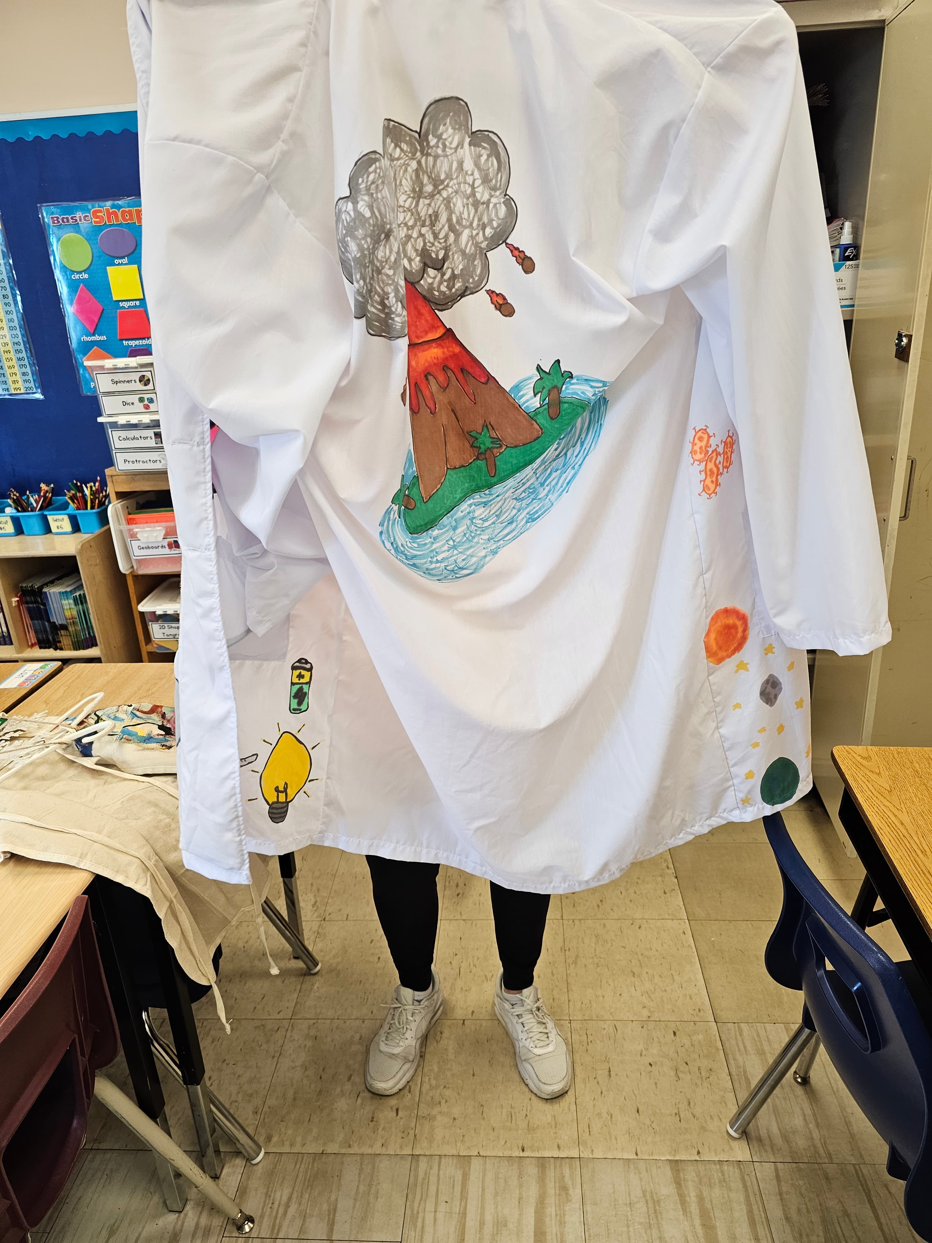 Science lab coat covered in hand-drawn illustrations of scientific concepts, displayed in a Grade 4/5 classroom at Highview Public School