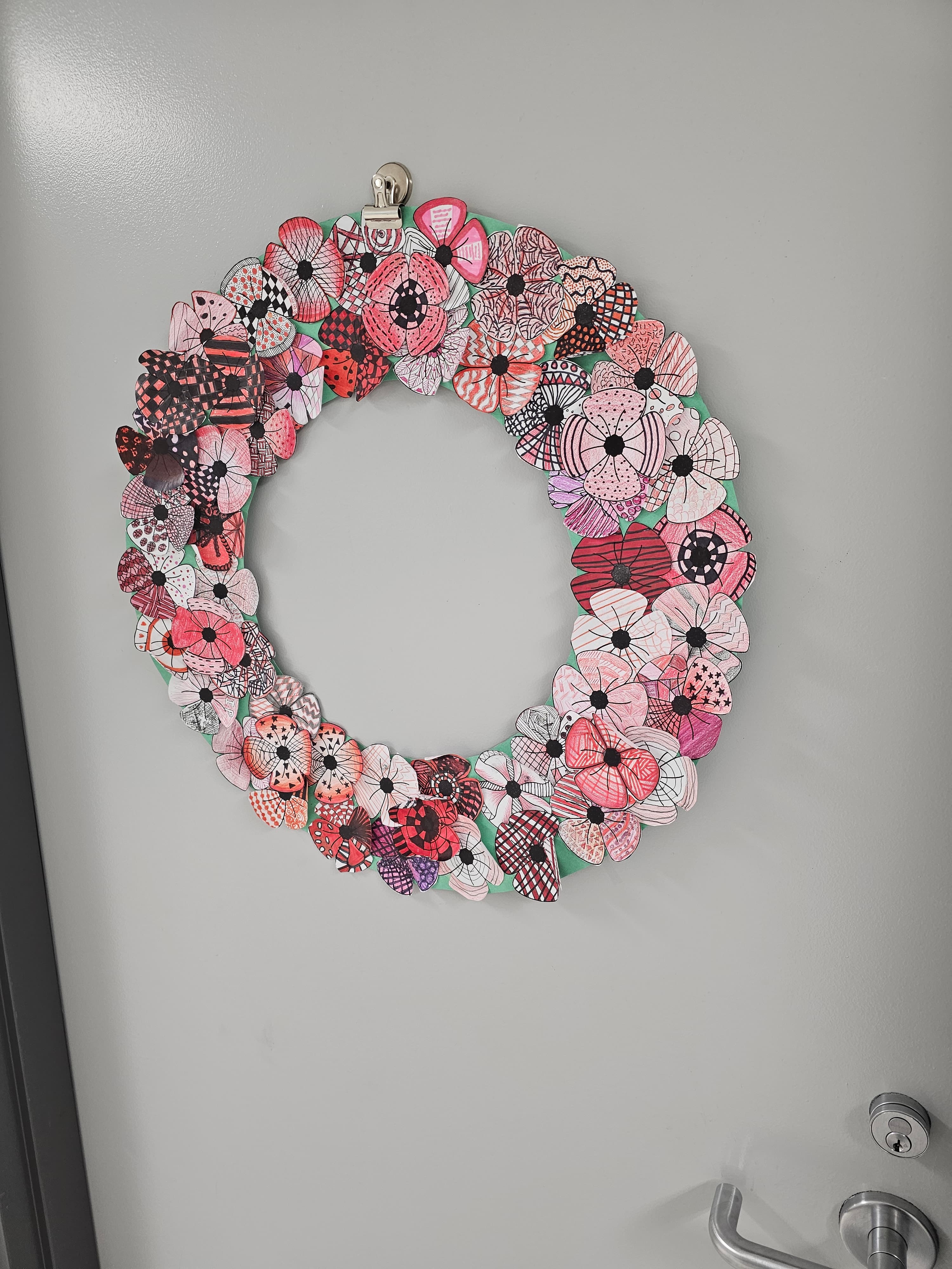 Wreath assembled from individually patterned paper flowers made by students at Rouge Park Public School